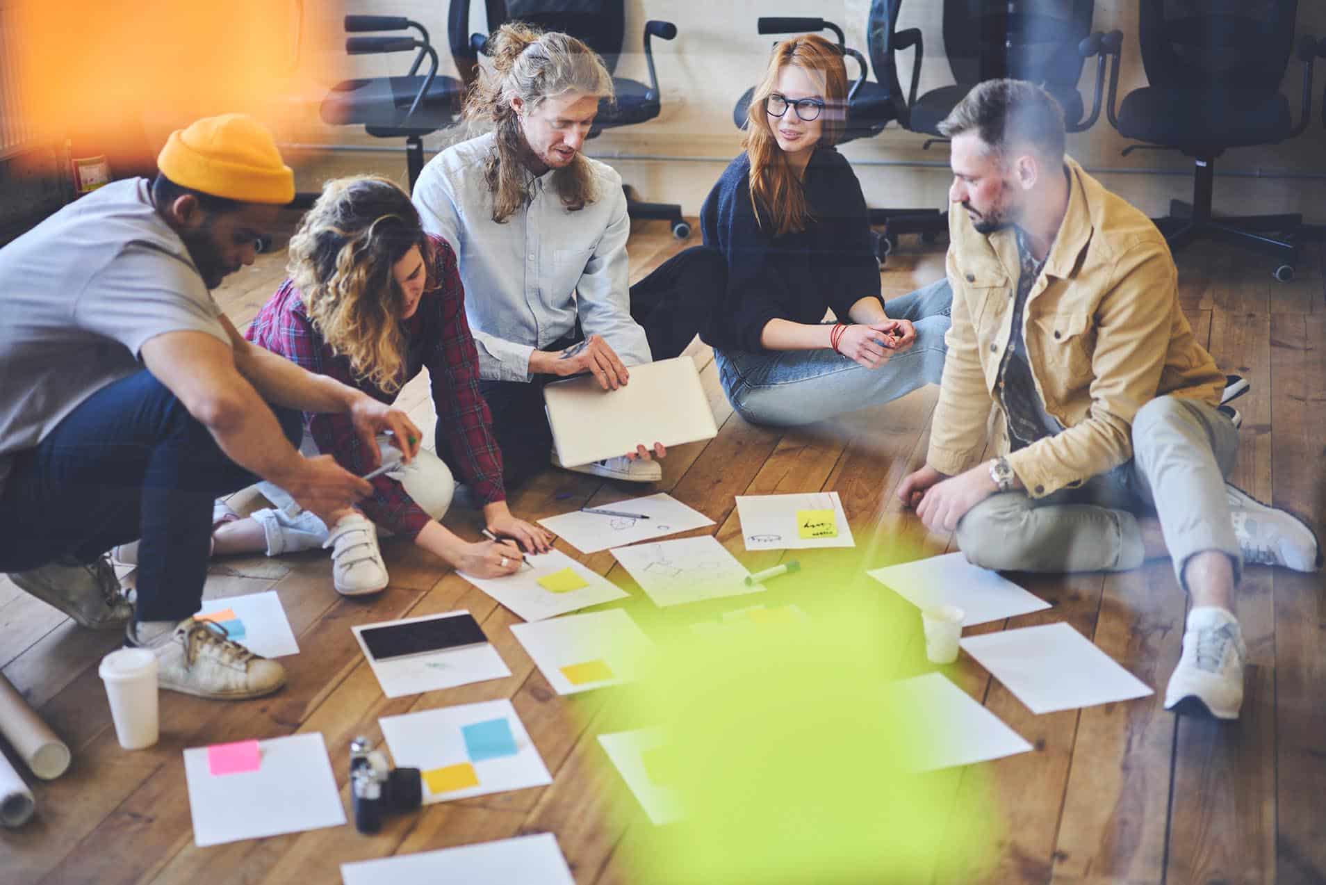 Dream team of hipster student collaborating preparing coursework together making planning and analyzing information, talented male and female colleagues creating business plan brainstorming on meeting