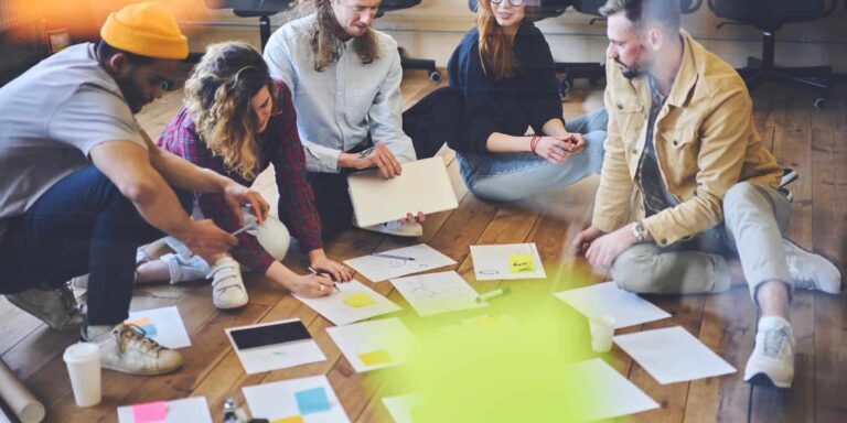Dream team of hipster student collaborating preparing coursework together making planning and analyzing information, talented male and female colleagues creating business plan brainstorming on meeting